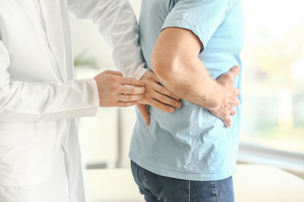 Urologist examining a male patient.